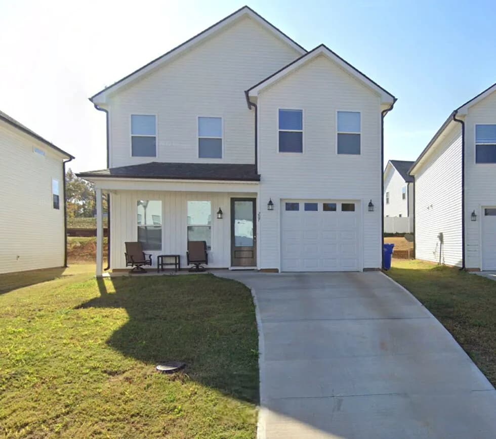 A newly built two-story home with a covered front porch and garage in the Travelers Rest community
