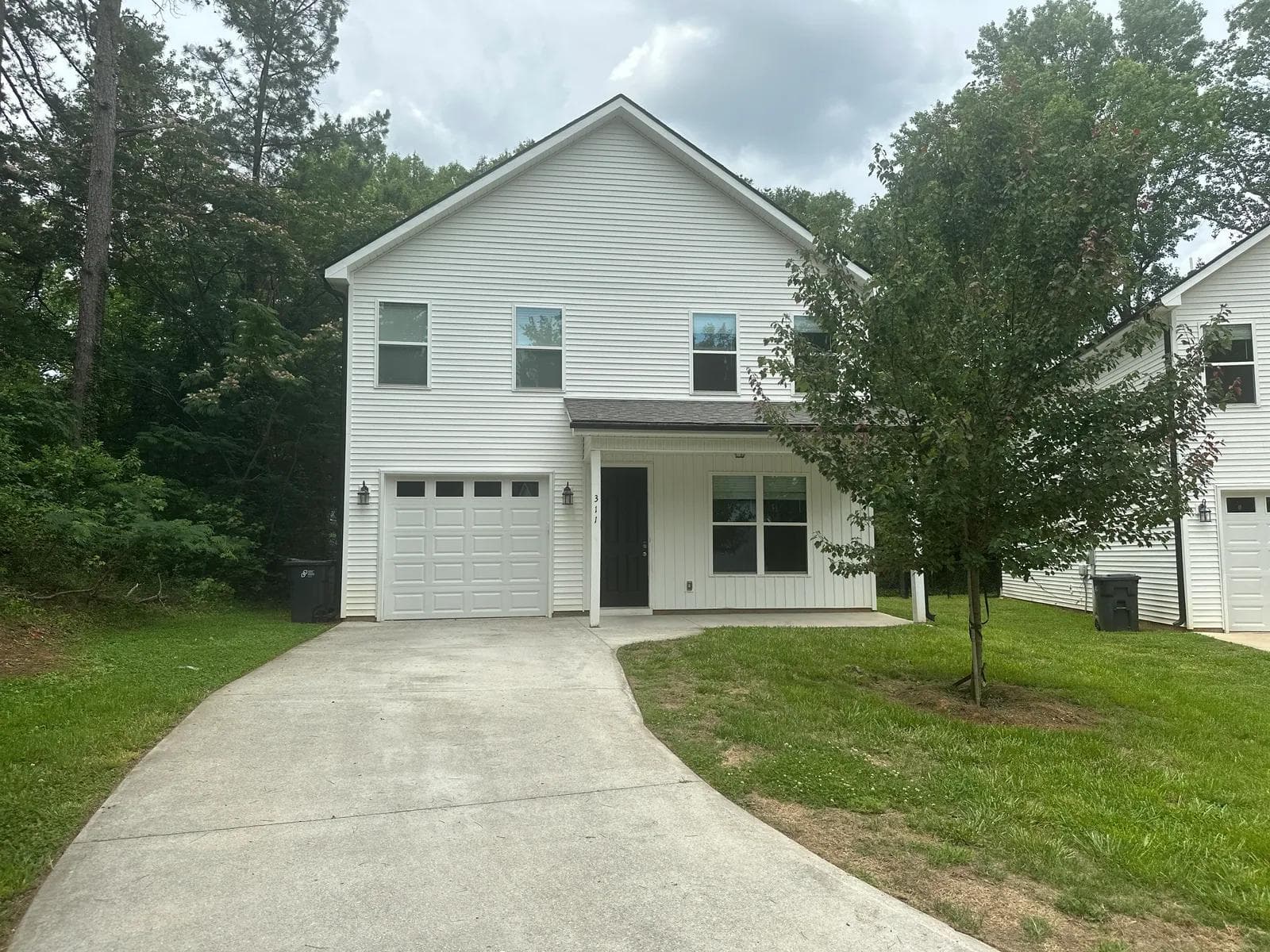 Exterior of 311 Clarus Creek Way — a two-story home with attached garage and covered porch in Travelers Rest, SC